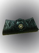 Amazing black raxin made purse is beautified with metal brooch with diamonds. Metal handle covered with rexin. It is handy to carry and impress to all in everywhere. This purse used in parties. Slight Color variations are possible due to differing screen and photograph resolutions.