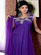 Be ready to slip in the comfort zone of this purple anarkali suit. This pretty Kameez is embellished with stylish patch pattern on neckline done with sequins, cutdana, stone, diamond and kasab work.  Lace border on kameez make attractive to impress all. Stylish neck pattern is stunning and gives a pretty look. Matching dupatta and churidar is available. This drape material is net with inner. The entire ensemble makes an excellent wear. Slight Color variations are possible due to differing screen and photograph resolutions.
