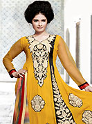 Dreamy variation on shape and forms compliment your style with tradition. The golden yellow georgette churidar suit have amazing embroidery and patch work. Embroidery is done with resham work in form of floral and paisley motifs. Beautiful embroidery work on kameez is stunning. The entire ensemble makes an excellent wear. Contrasting black santoon churidar and multicolor chiffon dupatta is available with this suit. Slight Color variations are possible due to differing screen and photograph resolutions.
