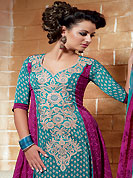 The glamorous silhouette to meet your most dire fashion needs. The dazzling turquoise blue and magenta crepe churidar suit have amazing floral print and embroidery patch work is done with resham, zari and beads work. The entire ensemble makes an excellent wear. Matching magenta churidar and printed dupatta is available with this suit. Slight Color variations are possible due to differing screen and photograph resolutions.