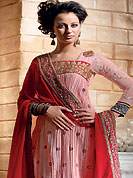 The glamorous silhouette to meet your most dire fashion needs. The dazzling pink crush crepe churidar suit have amazing floral print and embroidery patch work is done with resham, zari, sequins and applique work. The entire ensemble makes an excellent wear. Contrasting red churidar and dupatta is available with this suit. Slight Color variations are possible due to differing screen and photograph resolutions.