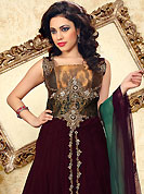 Outfit is a novel ways of getting yourself noticed. The dazzling dark burgundy net churidar suit have amazing embroidery patch bordered work is done with cutdana, stones, bugle beads and antique zardosi work. Beautiful embroidery work on kameez is stunning. The entire ensemble makes an excellent wear. Contrasting green churidar and double dye dupatta is available with this suit. Slight Color variations are possible due to differing screen and photograph resolutions.