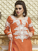 The very silhouette and styling of this outfit proves quiet flattering for most body types and renders a rather grand and majestic appeal. The dazzling rust cotton churidar suit have amazing embroidery patch work is done with resham, stone and lace work. The entire ensemble makes an excellent wear. Matching churidar and chiffon dupatta is available with this suit. Slight Color variations are possible due to differing screen and photograph resolutions.