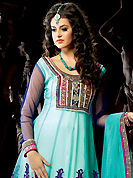 It is color this season and bright shaded suits are really something that is totally in vogue. The dazzling aqua blue net churidar suit have amazing embroidery patch work is done with resham, zari, sequins, stone, beads and lace work. Beautiful embroidery work on kameez is stunning. The entire ensemble makes an excellent wear. Contrasting purple santoon churidar and aqua blue net dupatta is available with this suit. Slight Color variations are possible due to differing screen and photograph resolutions.