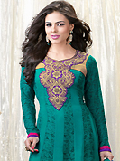 The glamorous silhouette to meet your most dire fashion needs. The dazzling turquoise green faux georgette churidar suit have amazing floral print and embroidery patch work is done with resham work. Beautiful embroidery work on kameez is stunning. The entire ensemble makes an excellent wear. Contrasting purple santoon churidar and turquoise green chiffon dupatta is available with this suit. Slight Color variations are possible due to differing screen and photograph resolutions.