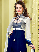 A desire that evokes a sense of belonging with a striking details. The dazzling navy blue faux georgette churidar suit have amazing embroidery patch work is done with resham, zari, sequins and stone work. Beautiful embroidery work on kameez is stunning. The entire ensemble makes an excellent wear. Matching santoon churidar and double dye dupatta is available with this suit. Slight Color variations are possible due to differing screen and photograph resolutions.