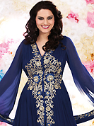 Get ready to sizzle all around you by sparkling suit. The dazzling dark blue georgette churidar suit have amazing embroidery patch work is done with resham, sequins and stone work. Beautiful embroidery work on kameez is stunning. The entire ensemble makes an excellent wear. Matching santoon churidar and chiffon dupatta is available with this suit. Slight Color variations are possible due to differing screen and photograph resolutions.