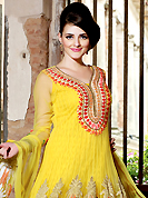 Take a look on the changing fashion of the season. The dazzling yellow net anarkali churidar suit have amazing embroidery patch work is done with resham, zari, sequins and lace work. Beautiful embroidery work on kameez is stunning. The entire ensemble makes an excellent wear. Matching churidar and dupatta is available with this suit. Slight Color variations are possible due to differing screen and photograph resolutions.