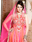 Outfit is a novel ways of getting yourself noticed. The dazzling shaded pink and orange net anarkali churidar suit have amazing embroidery patch work is done with resham, zari, sequins, stone, beads and lace work. Beautiful embroidery work on kameez is stunning. The entire ensemble makes an excellent wear. Matching pink churidar and pink dupatta is available with this suit. Slight Color variations are possible due to differing screen and photograph resolutions.