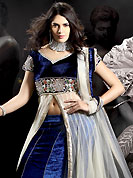 Today’s fashion is really about sensuality which can be seen in this creation. This dark blue and off white net and velvet lehenga choli is nicely embroidered and patch work done with stone and beads work in form of floral motifs. Embroidery long jacket style choli on lehenga is stunning. The beautiful embroidery on lehenga made it awesome and gives you stylish and attractive look to others. Matching choli and dupatta is availble with this lehenga. Slight Color variations are possible due to differing screen and photograph resolutions.