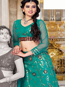 It’s cool and has a very modern look to impress all. This teal green net and shimmer lehenga choli is nicely embroidered and patch work done with resham, zari and sequins work. The beautiful embroidery on lehenga made it awesome and gives you stylish and attractive look to others. Matching choli and dupatta is availble with this lehenga. Slight Color variations are possible due to differing screen and photograph resolutions.