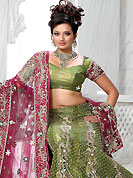 Let your personality speak for you this wedding lehenga embellished with embroidery work. This olive green net lehenga is nicely embroidered and velvet patch work is done with stone, zardosi, cutdana and cutbeads work. The beautiful embroidery on lehenga made it awesome and gives you stylish and attractive look to others. Matching choli and deep pink dupatta is availble with this lehenga. Slight Color variations are possible due to differing screen and photograph resolutions.