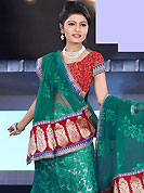 Take a look on the changing fashion of the season. This teal green shimmer and net lehenga is nicely embroidered patch work is done with resham, zari, sequins, stone and lace work. The beautiful embroidery on lehenga made it awesome and gives you stylish and attractive look to others. Contrasting red choli and teal green net dupatta is availble with this lehenga. Slight Color variations are possible due to differing screen and photograph resolutions.