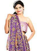 Embroidered lehengas are highly in order on a range of occasions such as wedding, formal party and festivals. This beige brown and purple net lehenga is nicely embroidered patch work is done with cutdana, sequins, stone, beads and cutbeads work. The beautiful embroidery on lehenga made it awesome and gives you stylish and attractive look to others. Matching choli and dupatta is availble with this lehenga. Slight Color variations are possible due to differing screen and photograph resolutions.