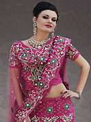 Elegance and innovation of designs crafted for you. This dark pink net lehenga choli is nicely embroidery and velvet patch work is done with stone, zardosi, cutdana, beads and cutbeads work. All over embroidery work on lehenga is stunning. The beautiful heavy embroidery on lehenga made it awesome and gives you stylish and attractive look to others. Matching choli and dupatta is availble with this lehenga. Slight Color variations are possible due to differing screen and photograph resolutions.