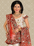 Make your collection more attractive and charming with this impressive dress. This white net a-line lehenga is nicely embroidered and velvet patch work is done with stone and cutbeads work. The beautiful embroidery on lehenga made it awesome and gives you stylish and attractive look to others. Matching choli and red net dupatta is availble with this lehenga. Slight Color variations are possible due to differing screen and photograph resolutions.