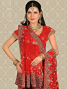 The evolution of style species collection spells pure femininity. This red net a-line lehenga is nicely embroidered patch work is done with zari, sequins, stone and cutbeads work. The beautiful embroidery on lehenga made it awesome and gives you stylish and attractive look to others. Matching choli and dupatta is availble with this lehenga. Slight Color variations are possible due to differing screen and photograph resolutions.