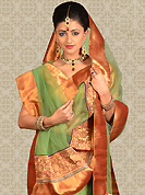Get ready to sizzle all around you by sparkling lehenga. This green net a-line lehenga is nicely embroidered patch work is done with zari and gota patti work. The beautiful embroidery on lehenga made it awesome and gives you stylish and attractive look to others. Matching choli and dupatta is availble with this lehenga. Slight Color variations are possible due to differing screen and photograph resolutions.
