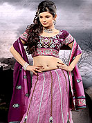 The glamorous silhouette to meet your most dire fashion needs. A beautiful lehenga choli nicely designed with resham, zari, sequins worked embroidered velvet patch and fabric lace patch in paisley patterns. This lehenga made with net and brocade fabric. Matching blouse and graceful dupatta is available. Slight Color variations are possible due to differing screen and photograph resolutions.