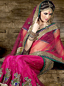 Dreamy variation on shape and forms compliment your style with tradition. This deep pink net fish cut lehenga choli is nicely embroidered with resham, sequins, stone, zari and patch work done in form of floral motiff. Matching banarasi opara silk blouse with net dupatta available with this. All over broad embroidered banarasi and dupion silk patch patti and beautiful embroidery in lehenga is enhancing the beauty of this lehenga. Lehenga waist can be customize upto 42 inches, length 40 inches and the bust size is upto 40 inches. As shown lehenga is available. Accessories shown in the image is just for photography purpose. Slight color variations are possible due to differing screen and photograph resolution.
