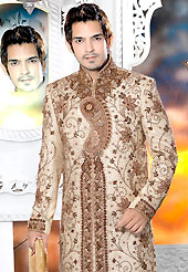 Today fashion is really about sensuality which can be seen in this creation. This light fawn sherwani embellished with stones, heavy zardosi, cutdana and patch work. The beautiful heavy embroidery on front border, collar and cuffs made it awesome and gives you stylish and attractive look to others. Contrasting churidar is enhanced your personality. This sherwani made with brocade fabric. Accessories shown in the image is just for photography purpose. Slight Color variations are possible due to differing screen and photograph resolutions.