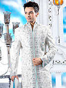 Make your collection more attractive with this dazzling dress. This off white sherwani embellished with zari, sequins, beads, stone and patch work. The beautiful heavy embroidery on front border, collar, back and cuffs made it awesome and gives you stylish and attractive look to others. Contrasting churidar is enhanced your personality. This sherwani made with cotton silk fabric. Accessories shown in the image is just for photography purpose. Slight Color variations are possible due to differing screen and photograph resolutions.