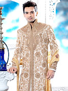 Make your collection more attractive with this dazzling dress. This cream sherwani embellished with heavy resham, zari, beads, sequins, stone and patch work. The beautiful heavy embroidery on front border, collar, back and cuffs made it awesome and gives you stylish and attractive look to others. Contrasting churidar is enhanced your personality. This sherwani made with cotton silk fabric. Accessories shown in the image is just for photography purpose. Slight Color variations are possible due to differing screen and photograph resolutions.