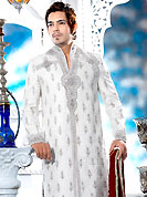 Its cool and have a very modern look to impress all. This off white sherwani embellished with all over self silver stone with resham, cutdana, beads and stone work. The beautiful heavy embroidery on front border, collar, back and cuffs made it awesome and gives you stylish and attractive look to others. Contrasting churidar is enhanced your personality. This sherwani made with jacquard fabric. Accessories shown in the image is just for photography purpose. Slight Color variations are possible due to differing screen and photograph resolutions.