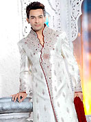 Today fashion is really about sensuality which can be seen in this creation. This off white elegant sherwani designed with all over beads, resham, zarkan, stone and patch work. The beautiful embroidery on front border, collar, back and cuffs made it awesome and gives you stylish and attractive look to others. Contrasting churidar is enhanced your personality. This sherwani made with brocade fabric. Accessories shown in the image is just for photography purpose. Slight Color variations are possible due to differing screen and photograph resolutions.
