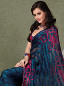 The very silhouette and styling of this outfit proves quiet flattering for most body types and renders a rather grand and majestic appeal. This navy blue sattan patti saree is nicely designed with beautiful print work in spiral and floral pattern. Floral patterned border is nice and looking impressive with nice colorblend. Matching blouse is available with this saree. Slight color variations possible due to differing screen and photograph resolution.
