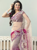 Get magnetic clad in this designer saree. This white and burgundy saree is beautifully designed with extensive embroidered border and butti patch work. Embroidery is done with resham, zari and sequins work. This fabulous party wear saree is specially crafted for your stunning and gorgeous look. This beautiful drape is crafted with net fabric. Matching blouse come along with this saree. Slight color variations are possible due to differing screen and photograph resolution.