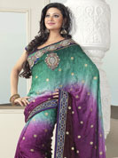 Your search for elegant look ends here with this lovely saree. This green and purple saree is beautifully designed with extensive embroidered border and butti patch work. Embroidery is done with resham, zari and sequins work. This fabulous party wear saree is specially crafted for your stunning and gorgeous look. This beautiful drape is crafted with crepe fabric. Matching blouse come along with this saree. Slight color variations are possible due to differing screen and photograph resolution.