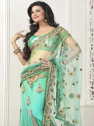 Envelope yourself in classic look with this charming saree. This light pastel green lehenga saree is beautifully designed with extensive embroidered border and butti patch work. Embroidery is done with resham, zari and sequins work. This fabulous party wear saree is specially crafted for your stunning and gorgeous look. This beautiful drape is crafted with net fabric. Matching blouse come along with this saree. Slight color variations are possible due to differing screen and photograph resolution.