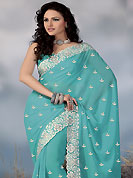 Get ready to sizzle all around you by sparkling saree. This aqua faux georgette saree have beautiful embroidery patch work which is embellished with resham and stone work in floral motifs. Fabulous designed embroidery gives you an ethnic look and increasing your beauty. Matching blouse is available. Slight Color variations are possible due to differing screen and photograph resolutions.