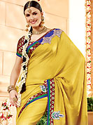 The glamorous silhouette to meet your most dire fashion needs. This golden yellow banarasi silk saree have beautiful embroidery patch work which is embellished with resham, zari and antique zardosi work. Fabulous designed embroidery gives you an ethnic look and increasing your beauty. Contrasting maroon blouse is available. Slight Color variations are possible due to differing screen and photograph resolutions.