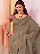 Style and trend will be at the peak of your beauty when you adorn this saree. This dark grey raw silk saree have beautiful embroidery patch work which is embellished with self weaving zari and resham work. Fabulous designed embroidery gives you an ethnic look and increasing your beauty. Matching blouse is available. Slight Color variations are possible due to differing screen and photograph resolutions.