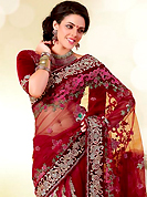 The glamorous silhouette to meet your most dire fashion needs. This maroon net saree is nicely designed with embroidered patch work is done with resham, zari, stone, beads and cutbeads work. Saree gives you a singular and dissimilar look. Matching blouse is available. Slight color variations are possible due to differing screen and photograph resolution.