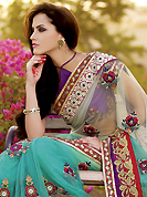 Exquisite combination of color, fabric can be seen here. This off white and aqua blue net saree is nicely designed with heavy embroidered patch work is done with resham, zari, beads, stone and kasab work. Beautiful embroidery patch border on saree make attractive to impress all. This saree gives you a modern and different look in fabulous style. Contrasting purple blouse is available with this saree. Slight color variations are possible due to differing screen and photograph resolution.
