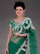 Exquisite combination of color, fabric can be seen here. This green net saree is nicely designed with embroidery patch work is done with stone work. Beautiful embroidery work on saree make attractive to impress all. This saree gives you a modern and different look in fabulous style. Matching blouse is available. Slight color variations are possible due to differing screen and photograph resolution.