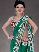 Breathtaking collection of sarees with stylish embroidery work and fabulous style. This green net saree is nicely designed with embroidery patch work is done with resham, stone and cutbeads work. Beautiful embroidery work on saree make attractive to impress all. This saree gives you a modern and different look in fabulous style. Contrasting red velvet blouse is available. Slight color variations are possible due to differing screen and photograph resolution.