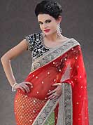 Get ready to sizzle all around you by sparkling saree. This red and light green net and chanderi saree is nicely designed with embroidery patch work is done with stone, zardosi, beads and cutbeads work. Beautiful embroidery work on saree make attractive to impress all. This saree gives you a modern and different look in fabulous style. Contrasting black velvet blouse is available. Slight color variations are possible due to differing screen and photograph resolution.