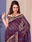 Take the fashion industry by storm in this beautiful embroidered saree. This beautiful dusty violet and dusty fawn tissue saree is nicely designed with floral print, zari, stone and graceful patch border. Beautiful print work on saree make attractive to impress all. It will enhance your personality and gives you a singular look. Contrasting maroon blouse is available with this saree. Slight color variations are due to differing screen and photography resolution.