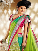 It is color this season and bright shaded suits are really something that is totally in vogue. This pastel green and green georgette and net lehenga style saree is nicely designed with embroidery patch work is done with resham, zari, sequins and stone work. Beautiful embroidery work on saree make attractive to impress all. This saree gives you a modern and different look in fabulous style. Contrasting dark pink raw silk blouse is available. Slight color variations are possible due to differing screen and photograph resolution.