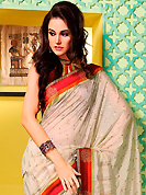 Take the fashion industry by storm in this beautiful embroidered saree. This off white art silk saree is nicely designed with foil print and patch bordered work. Beautiful embroidery work on saree make attractive to impress all. This saree gives you a modern and different look in fabulous style. Contrasting maroon blouse is available. Slight color variations are possible due to differing screen and photograph resolution.