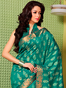 Make a trendy look with this classic embroidered saree. This teal green art silk saree is nicely designed with floral print, self weaving zari and patch bordered work. Beautiful embroidery work on saree make attractive to impress all. This saree gives you a modern and different look in fabulous style. Matching blouse is available. Slight color variations are possible due to differing screen and photograph resolution.