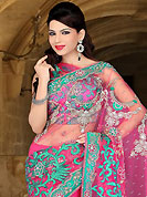 Make a trendy look with this classic embroidered saree. This pink net saree have beautiful embroidery patch work which is embellished with resham, sequins, stone and cutbeads work. Fabulous designed embroidery gives you an ethnic look and increasing your beauty. Matching blouse is available. Slight Color variations are possible due to differing screen and photograph resolutions.