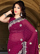 The evolution of style species collection spells pure femininity. This burgundy faux georgette saree have beautiful embroidery patch work which is embellished with sequins, stone, cutdana and cutbeads work. Fabulous designed embroidery gives you an ethnic look and increasing your beauty. Matching blouse is available. Slight Color variations are possible due to differing screen and photograph resolutions.