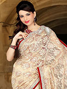 This season dazzle and shine in pure colors. This cream net saree have beautiful embroidery patch work which is embellished with sequins, stone, cutdana and cutbeads work. Fabulous designed embroidery gives you an ethnic look and increasing your beauty. Contrasting red blouse is available. Slight Color variations are possible due to differing screen and photograph resolutions.