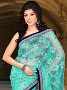 Ultimate collection of embroidered sarees with fabulous style. This sea green net saree have beautiful embroidery patch work which is embellished with silver zari, sequins and stone work. Fabulous designed embroidery gives you an ethnic look and increasing your beauty. Contrasting dark navy blue blouse is available. Slight Color variations are possible due to differing screen and photograph resolutions.