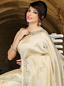 Style and trend will be at the peak of your beauty when you adorn this saree. This beige dupion silk saree have beautiful embroidery patch work which is embellished with sequins, stone and cutwork. Fabulous designed embroidery gives you an ethnic look and increasing your beauty. Matching blouse is available. Slight Color variations are possible due to differing screen and photograph resolutions.